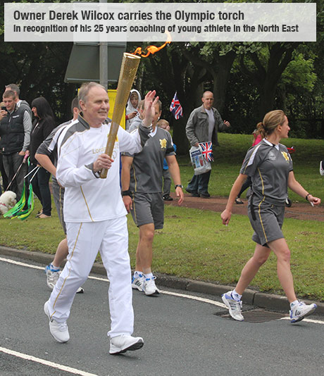 Owner carries olympic torch